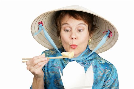 Tourist in Chinese clothing eating a dumpling from a takeout container.  Isolated on white. Stock Photo - Budget Royalty-Free & Subscription, Code: 400-03973063