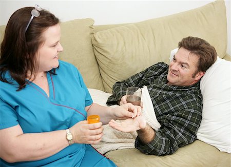 Home health care nurse giving a pill to her patient. Stock Photo - Budget Royalty-Free & Subscription, Code: 400-03973094