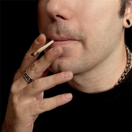 A man smoking a marijuana joint. Stock Photo - Budget Royalty-Free & Subscription, Code: 400-03973303