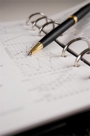 examine graphs - Stock chart with a pen Stock Photo - Budget Royalty-Free & Subscription, Code: 400-03984082