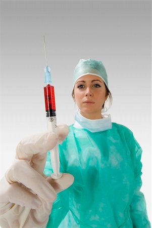 simsearch:400-05060422,k - a young nurse in operation dress with a syringe full of blood Stock Photo - Budget Royalty-Free & Subscription, Code: 400-03984223