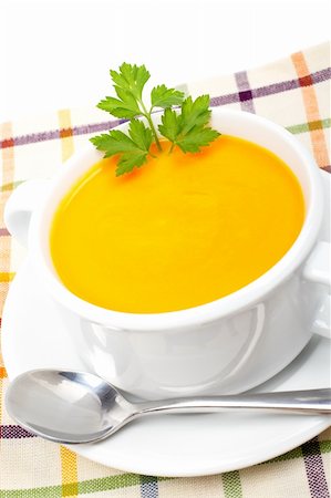 simsearch:400-07092695,k - Carrots puree and parsley on white cup with spoon over squared mat. Shallow DOF Photographie de stock - Aubaine LD & Abonnement, Code: 400-03984287