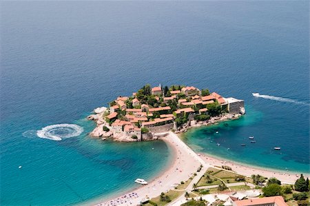 sveti stefan - An aerial view of Sveti Stefan showing the resort on its peninsula with the causeway connecting to the surrounding beaches and the blue water of the Adriatic Sea. Stock Photo - Budget Royalty-Free & Subscription, Code: 400-03984556