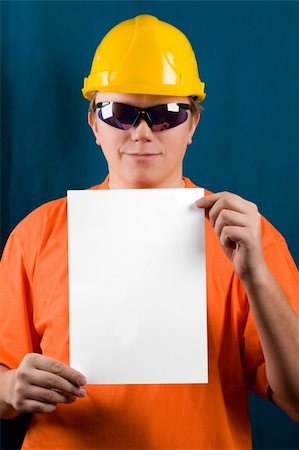 simsearch:400-04485729,k - The man in yellow helmet, orange shirt, glasses and paper a4. Add your text here. Isolated glasses, paper and background in different paths. Stock Photo - Budget Royalty-Free & Subscription, Code: 400-03984884