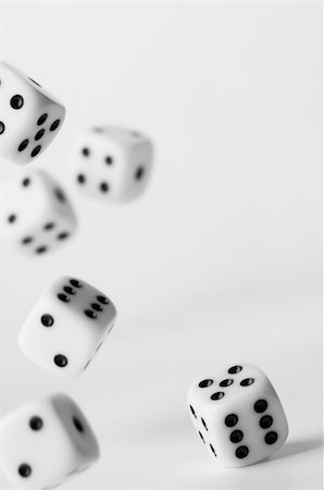 A single white dice in focus with falling dice in the background Foto de stock - Super Valor sin royalties y Suscripción, Código: 400-03985653