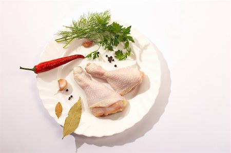 fresh chicken's legs and red pepper wih parsley on the plate Foto de stock - Super Valor sin royalties y Suscripción, Código: 400-03987135