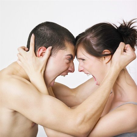 Young couple locked in angry embrace Stock Photo - Budget Royalty-Free & Subscription, Code: 400-03987739