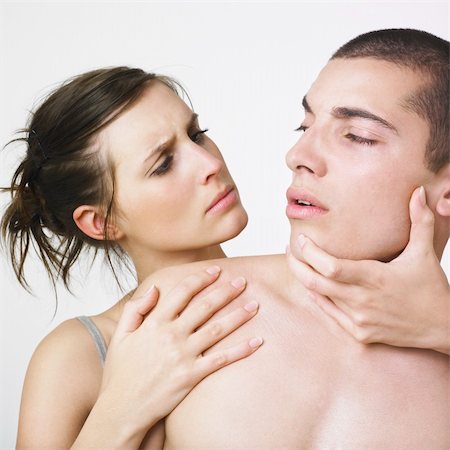 Couple looking at one another intensely; female has male face turned towards her and he is looking at her skeptically Stock Photo - Budget Royalty-Free & Subscription, Code: 400-03987753