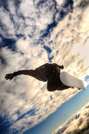 simsearch:400-04431636,k - Snowboarder launching off a jump; vertical orientation, warm afternoon light. Stockbilder - Microstock & Abonnement, Bildnummer: 400-03987948