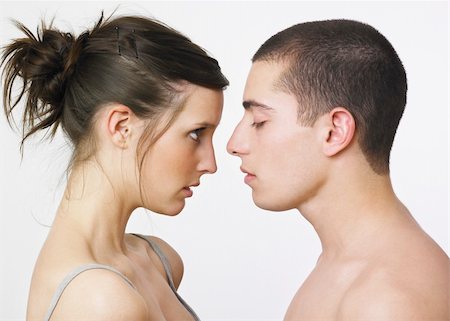 Young couple looking as if  about to kiss; woman is starting intensely at man . Foto de stock - Super Valor sin royalties y Suscripción, Código: 400-03988424