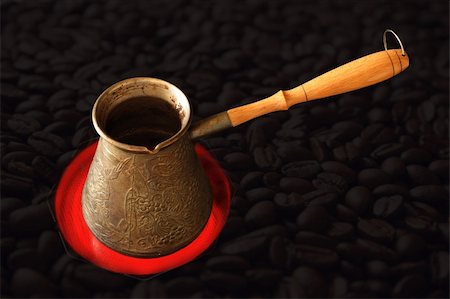 drinking can - making cofee on kitchen stove and cofee grains as background Stock Photo - Budget Royalty-Free & Subscription, Code: 400-03988831