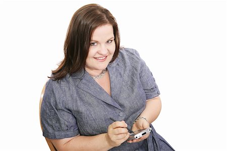 Pretty plus sized businesswoman checking appointments on her PDA.  Isolated on white. Stock Photo - Budget Royalty-Free & Subscription, Code: 400-03989274