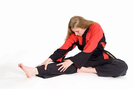 Female martial artist in red and black uniform stretching. Photographie de stock - Aubaine LD & Abonnement, Code: 400-03989565