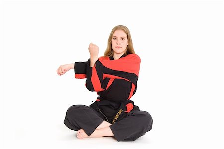 Female martial artist in red and black uniform stretching. Stock Photo - Budget Royalty-Free & Subscription, Code: 400-03989566