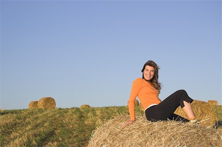 simsearch:400-04123668,k - Beautiful woman in a field with hay bales Stock Photo - Budget Royalty-Free & Subscription, Code: 400-03989631
