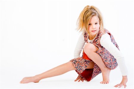 Studio portrait of a blond child stretching Stock Photo - Budget Royalty-Free & Subscription, Code: 400-03989738