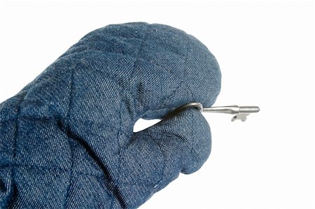 A blue oven mitt holding an old skeleton key.  Isolated on white with clipping path. Stock Photo - Budget Royalty-Free & Subscription, Code: 400-03983657