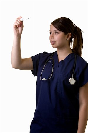 simsearch:400-03995908,k - Hispanic woman healthcare worker wearing dark blue scrubs and a stethoscope looking at the reading of a thermometer standing on white Stock Photo - Budget Royalty-Free & Subscription, Code: 400-03994209