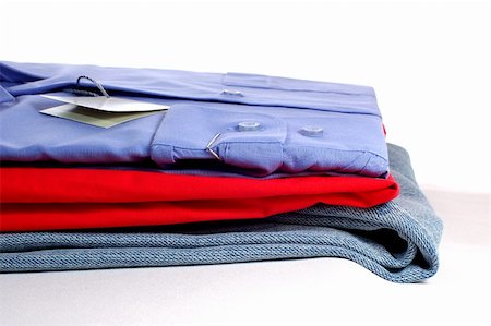 stack shirts not people - some new clothers on grey podium, isolated on white Stock Photo - Budget Royalty-Free & Subscription, Code: 400-03994575