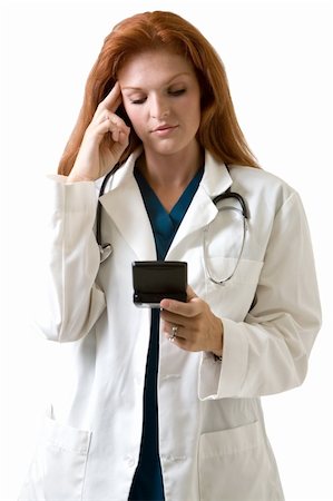 simsearch:400-03995908,k - Female attractive red hair doctor wearing white lab coat with a stethoscope around shoulders and holding a pager with finger on forehead with a worried or stressed expression on white background Stock Photo - Budget Royalty-Free & Subscription, Code: 400-03994651