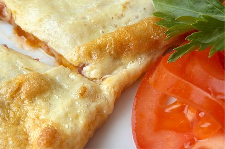 flat omelet stuffed with ham, with tomato and parsley, selective focus Stock Photo - Budget Royalty-Free & Subscription, Code: 400-03995144