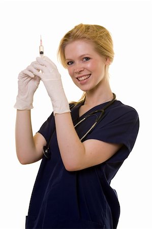 simsearch:400-03995908,k - Young pretty blond woman healthcare worker wearing blue scrubs and a stethoscope holding up a syringe or needle wearing latex gloves standing on white Stock Photo - Budget Royalty-Free & Subscription, Code: 400-03995404