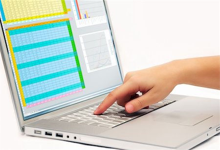 Image shows a finger pressing a key on a contemporary laptop  displaying a business spreadsheet Fotografie stock - Microstock e Abbonamento, Codice: 400-03995561