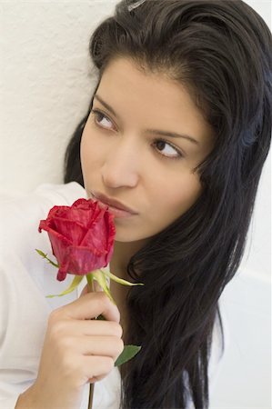 simsearch:400-04509114,k - Studio portrait of a stunningly beautiful hispanic girl smelling a red rose Stock Photo - Budget Royalty-Free & Subscription, Code: 400-03995575