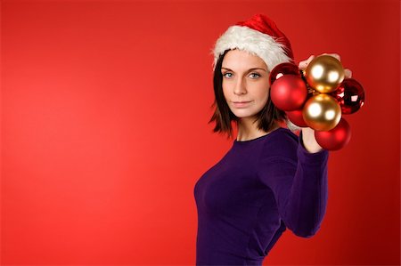 simsearch:614-02984866,k - A young female holding up christmas decorations Stockbilder - Microstock & Abonnement, Bildnummer: 400-03996794