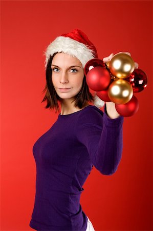 simsearch:614-02984866,k - A young female holding up christmas decorations Stockbilder - Microstock & Abonnement, Bildnummer: 400-03996792