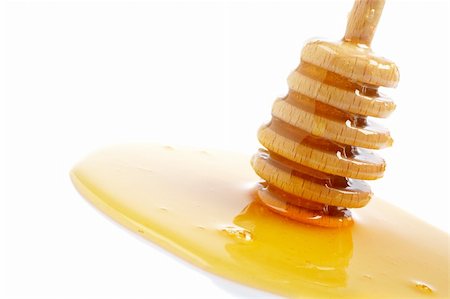 simsearch:400-04865454,k - Honey and wooden drizzler, reflected on white background. Shallow DOF Stockbilder - Microstock & Abonnement, Bildnummer: 400-03996922