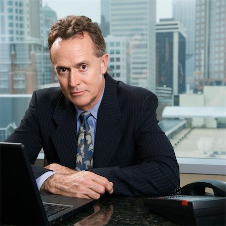 simsearch:400-04186486,k - Middle-aged Caucasian male in office with skyline in background. Stock Photo - Budget Royalty-Free & Subscription, Code: 400-03998255