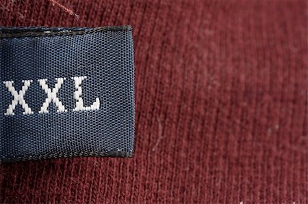 The XXL tag on a men's sweater Stockbilder - Microstock & Abonnement, Bildnummer: 400-03998568