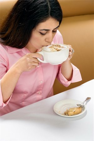 Attractive Hispanic woman drinking cappuccino. Stock Photo - Budget Royalty-Free & Subscription, Code: 400-03999210