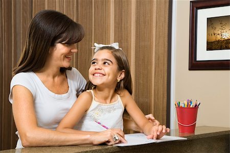 simsearch:640-03262671,k - Hispanic mother helping daughter making eye contact and working on homework. Stock Photo - Budget Royalty-Free & Subscription, Code: 400-03999348