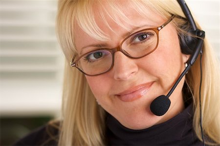 simsearch:400-04001946,k - Attractive businesswoman talks on her phone headset. Foto de stock - Super Valor sin royalties y Suscripción, Código: 400-03999648