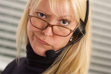 simsearch:400-05098432,k - Goofy businesswoman talks on her phone headset. Photographie de stock - Aubaine LD & Abonnement, Code: 400-03999650