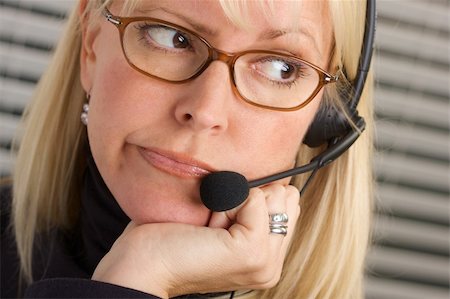 simsearch:400-08293929,k - Attractive businesswoman talks on her phone headset. Stock Photo - Budget Royalty-Free & Subscription, Code: 400-03999653