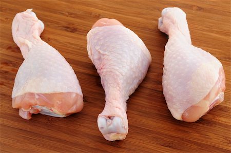 raw chicken on cutting board - Raw chicken drumsticks on a wooden cutting board Stock Photo - Budget Royalty-Free & Subscription, Code: 400-03999777