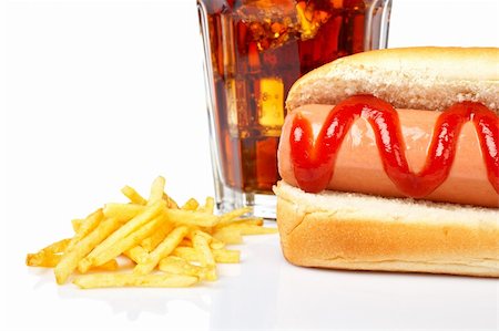 simsearch:400-06425636,k - Hot dog, soda glass and french fries on white background. Shallow DOF Photographie de stock - Aubaine LD & Abonnement, Code: 400-03999859