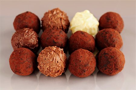 Several assorted chocolate truffles in rows on brown background Stock Photo - Budget Royalty-Free & Subscription, Code: 400-03990118