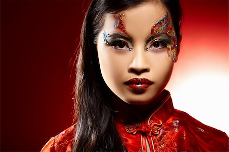 simsearch:400-04780842,k - Beautiful Asian girl as a plastic doll on red background Stock Photo - Budget Royalty-Free & Subscription, Code: 400-03990233