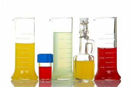 Assortment of test flasks with colored liquids, reflected on white background Stock Photo - Budget Royalty-Free & Subscription, Code: 400-03990929