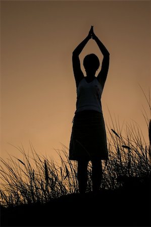 simsearch:400-05065940,k - female silhouette celebrating summer sunset, PERSON ISN'T IDENTIFABLE Stock Photo - Budget Royalty-Free & Subscription, Code: 400-03992107