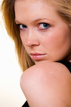 simsearch:400-04498992,k - Attractive close up of face of a woman with long blond hair and blue eyes with serious expression Photographie de stock - Aubaine LD & Abonnement, Code: 400-03992557