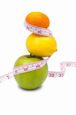 simsearch:400-05907063,k - Weight loss and healthy dieting concept. Apple, lemon and mandarin with measure tape. Isolated over white. Stock Photo - Budget Royalty-Free & Subscription, Code: 400-03992759