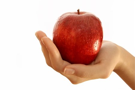 simsearch:400-04564926,k - Red apple in a girl hand. Isolated over white Photographie de stock - Aubaine LD & Abonnement, Code: 400-03992850
