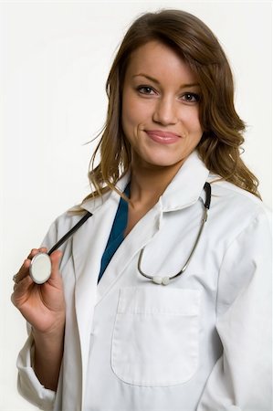 simsearch:400-03995908,k - Female attractive doctor wearing white lab coat with a stethoscope around shoulders smiling standing on white background Stock Photo - Budget Royalty-Free & Subscription, Code: 400-03993391