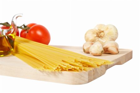 Tomatoes, olive oil, garlic and spaghetti, isolated on white background Stock Photo - Budget Royalty-Free & Subscription, Code: 400-03993916