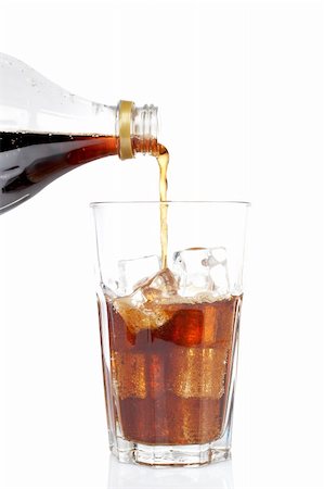 Pouring soda into a glass with ice cubes, reflected on white background. Shallow DOF Stock Photo - Budget Royalty-Free & Subscription, Code: 400-03993918